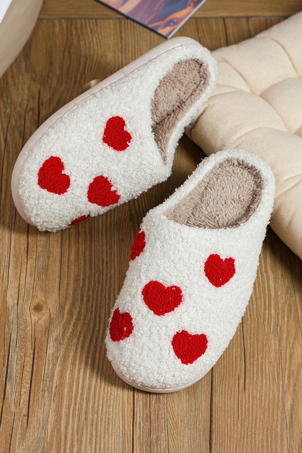Soft plush slippers with white heart design for warmth and comfort