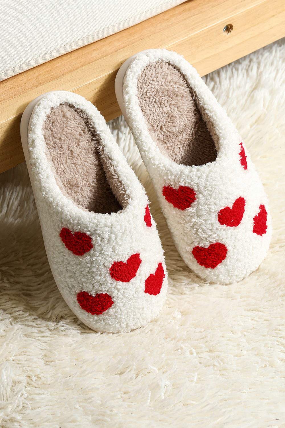Soft plush slippers with white heart design for warmth and comfort