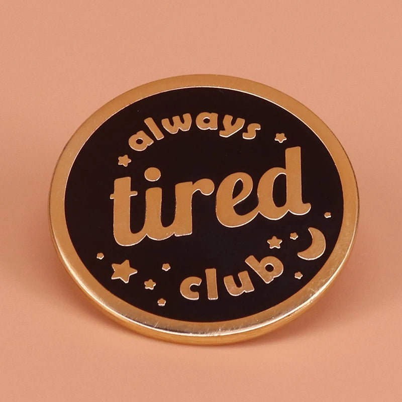 Always Tired Club enamel pin on denim jacket