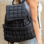 Stylish black puffer backpack with quilted pattern and spacious compartments