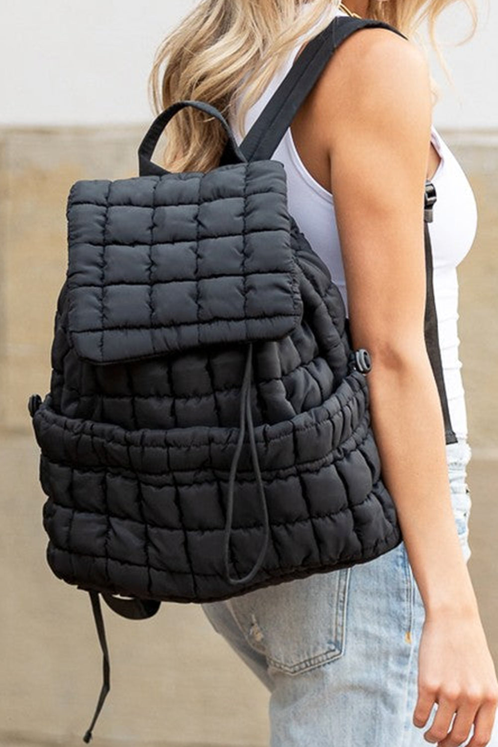 Stylish black puffer backpack with quilted pattern and spacious compartments