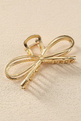 Chic gold bowknot hair accessory for sophisticated hairstyles