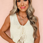 Trendy V neck design with lace-up details on beige sweater