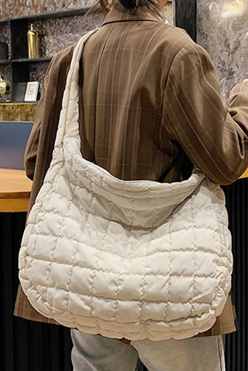 Spacious beige quilted large shoulder bag with a comfortable strap