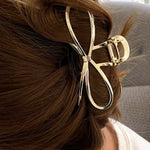 Chic gold bowknot hair accessory for sophisticated hairstyles