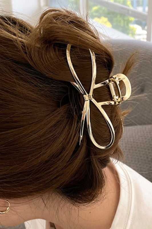 Chic gold bowknot hair accessory for sophisticated hairstyles