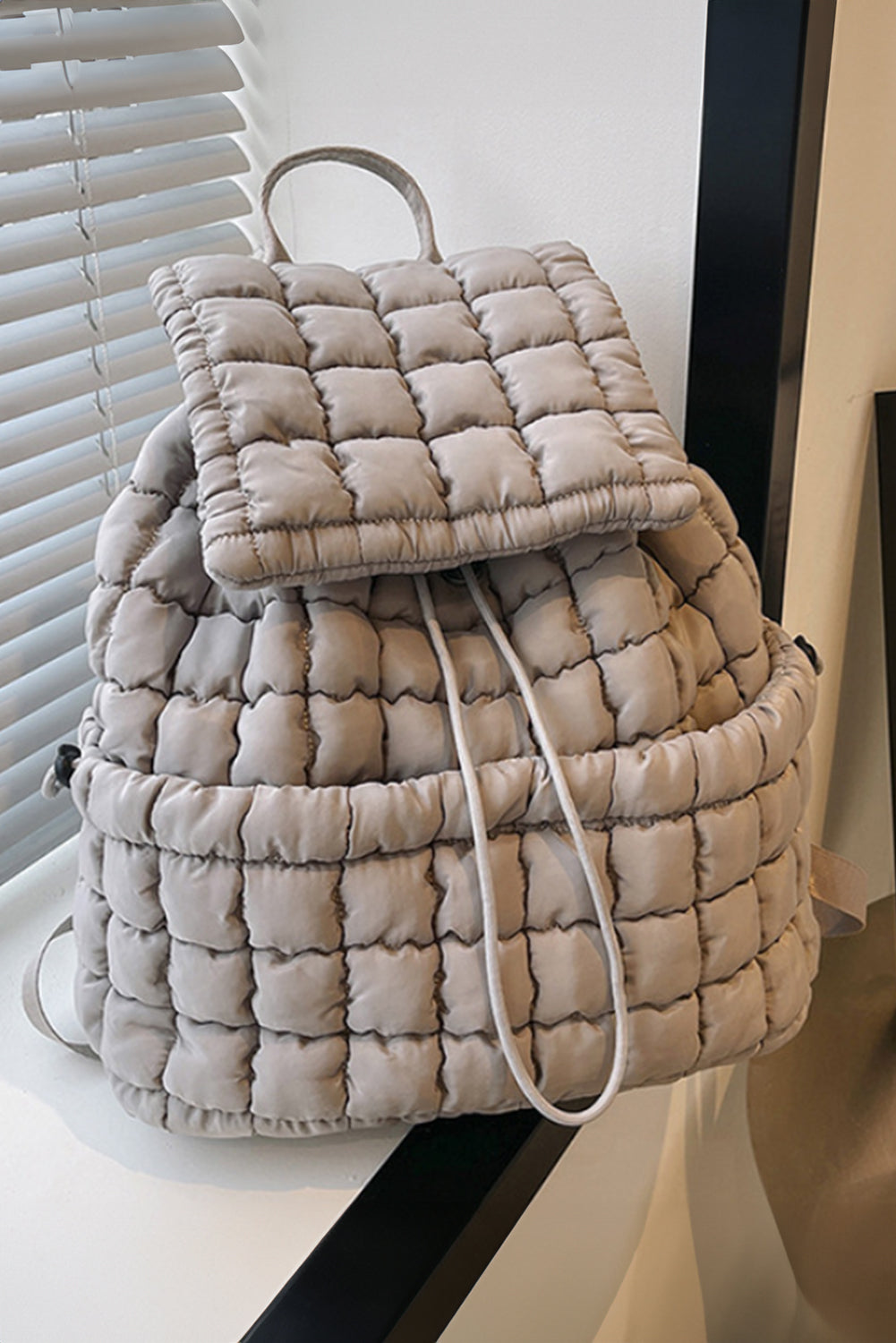 Modern black puffer backpack with quilted design and sleek look