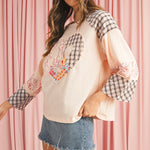Cozy beige long sleeve top with floral patchwork and heart design