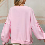 Feminine light pink sweatshirt with bow lantern sleeves.