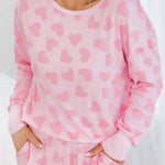 Cozy and stylish pink plus-size sweater with heart checkered design
