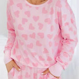 Cozy and stylish pink plus-size sweater with heart checkered design