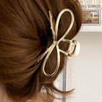 Gold metal bow hair clip for a trendy and refined style