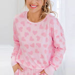 Trendy plus-size pink sweater with a heart pattern