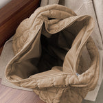 Spacious beige quilted large shoulder bag with a comfortable strap