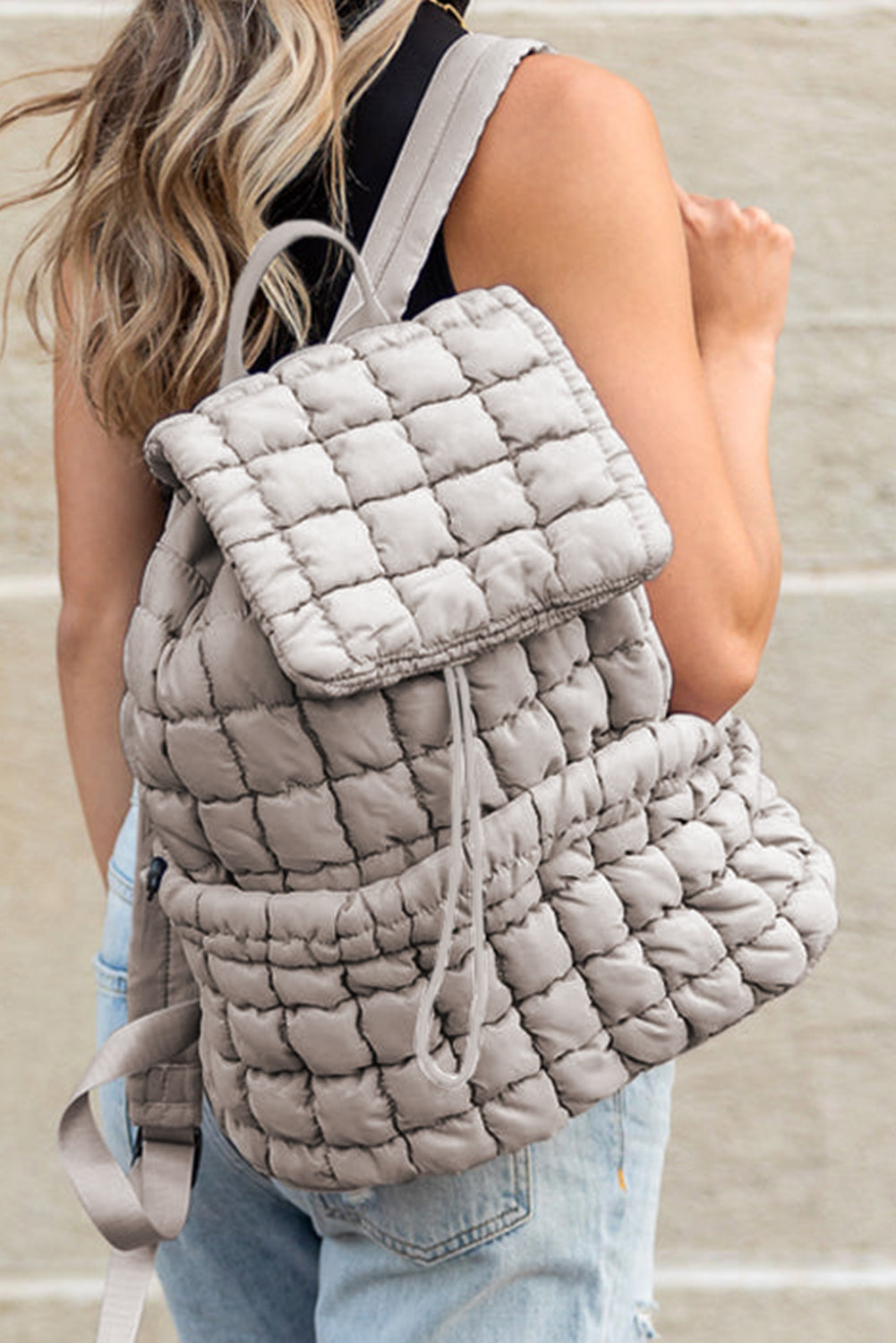 Modern black puffer backpack with quilted design and sleek look